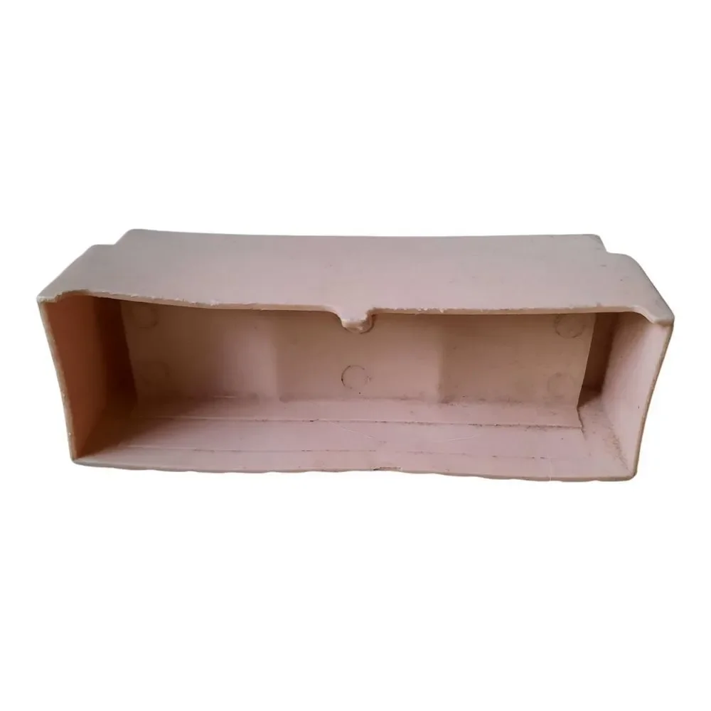 Marx hard plastic dollhouse sofa in a pale pink color.